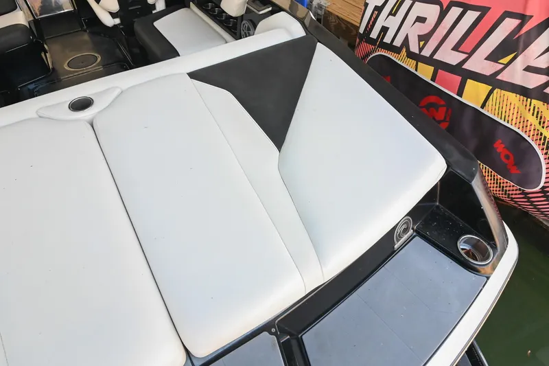 Slide: The Image of 2022 Axis A22 boat interior with sleek white seating and cup holders. - 11