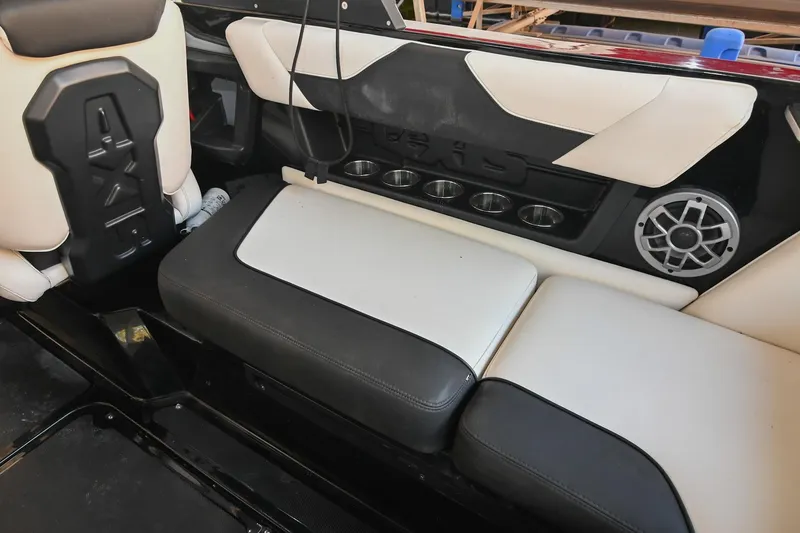 Slide: The Image of 2022 Axis A22 boat interior with cushioned seating and speaker system. - 16