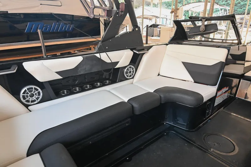 Slide: The Image of 2022 Axis A22 boat interior with black and white seating and built-in speakers. - 20