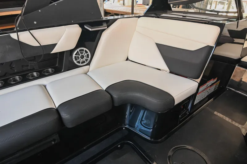 Slide: The Image of 2022 Axis A22 boat interior with black and white seating and built-in speaker. - 22