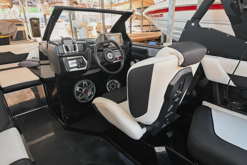 Slide: The Image of 2022 Axis A22 boat interior with modern dashboard and seating. - 25