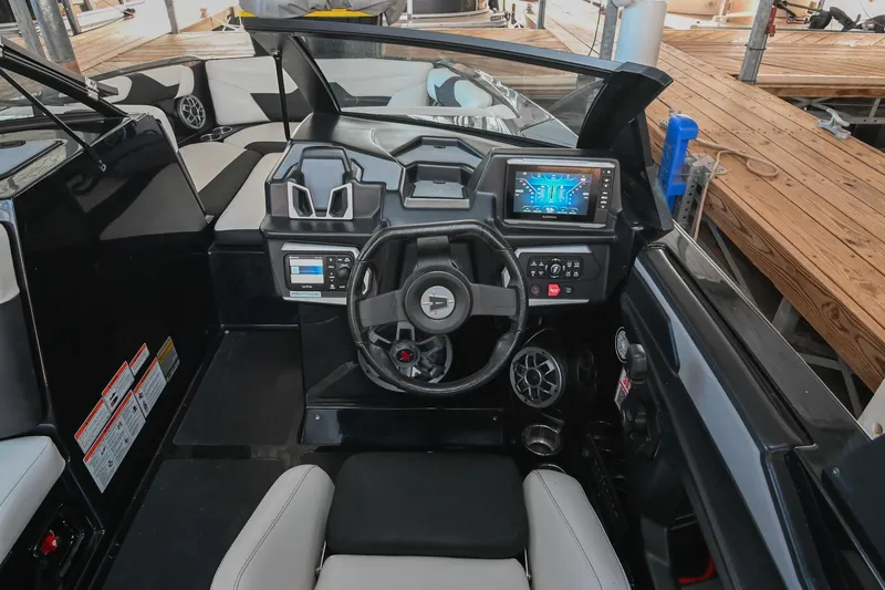 Slide: The Image of 2022 Axis A22 boat cockpit with modern steering and digital display. - 26
