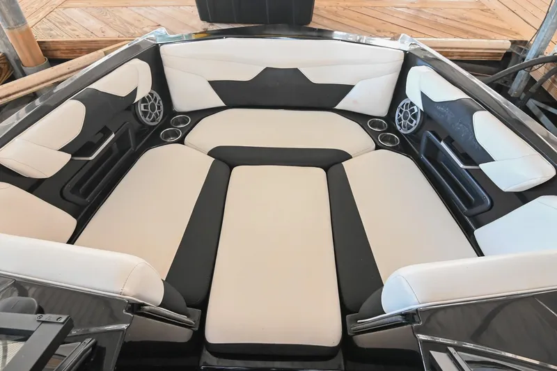 Slide: The Image of 2022 Axis A22 boat interior with cushioned seating and built-in speakers. - 32