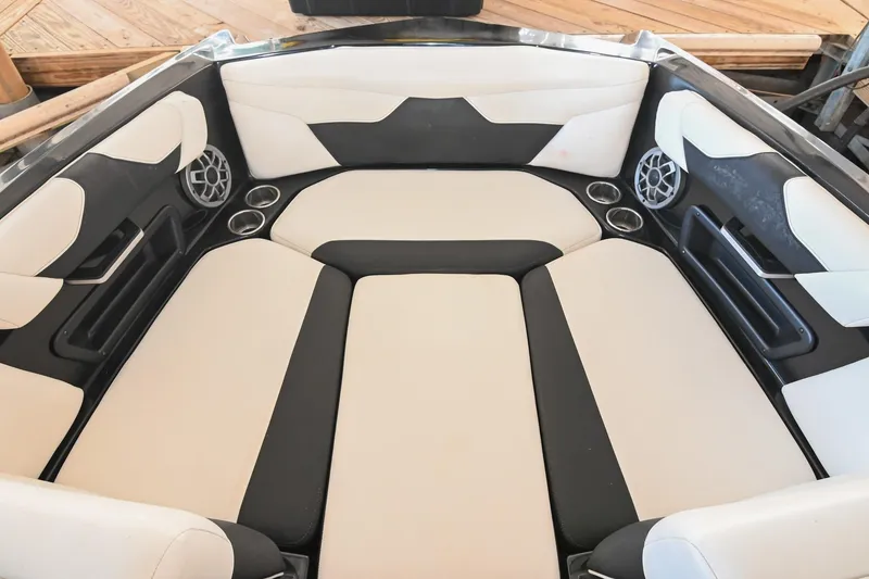 Slide: The Image of 2022 Axis A22 boat interior with cushioned seating and built-in speakers. - 37