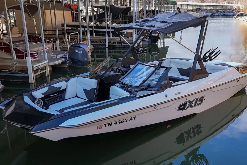 Slide: The Image of 2022 Axis A22 boat docked in marina, featuring sleek design and modern seating. - 4