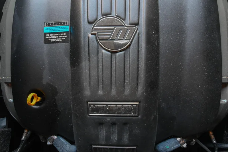 Slide: The Image of Engine cover of a 2022 Axis A22 with Monsoon branding and ISO certification label. - 43