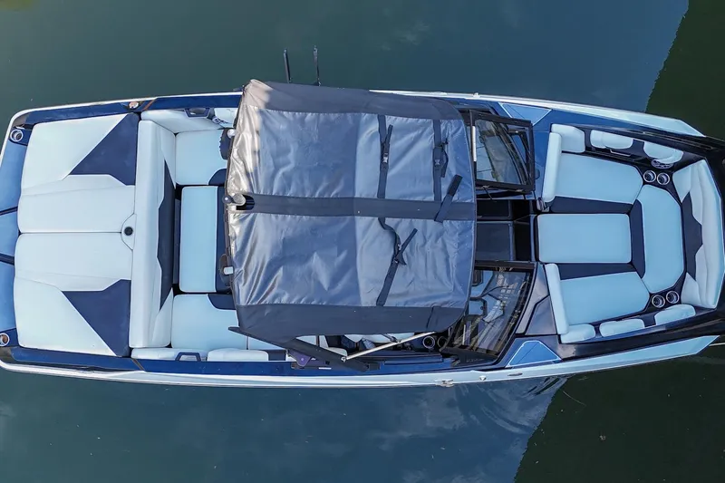 Slide: The Image of Overhead view of 2022 Axis A22 boat with blue and white seating on water. - 5