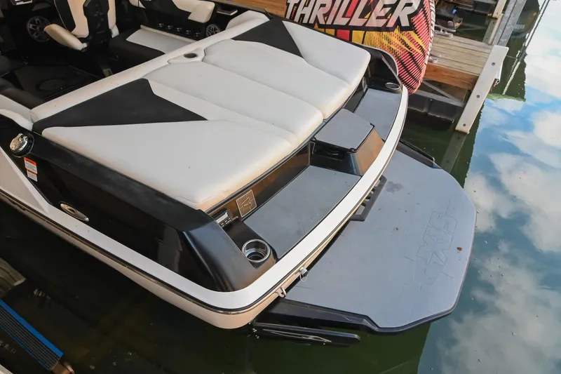 Slide: The Image of 2022 Axis A22 boat with cushioned seating and swim platform on calm water. - 8