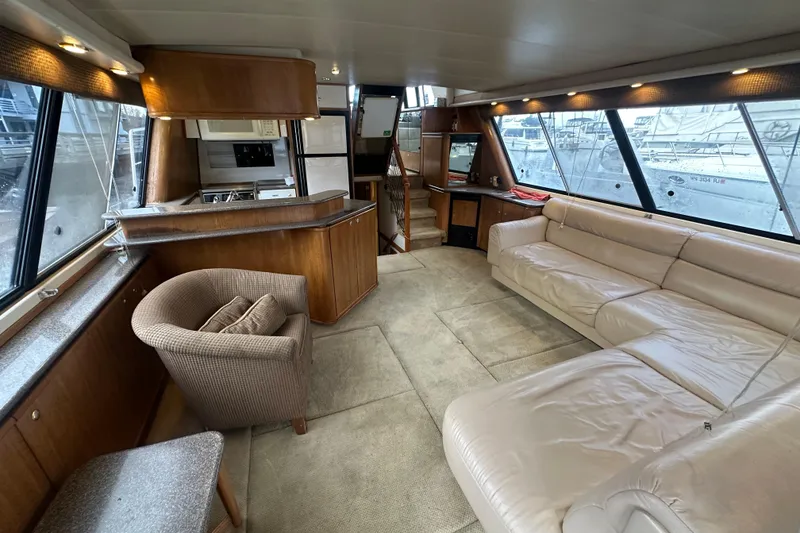 Slide: The Image of Interior of 1999 Bayliner 4788 Pilot House Motoryacht with spacious seating and modern amenities. - 10