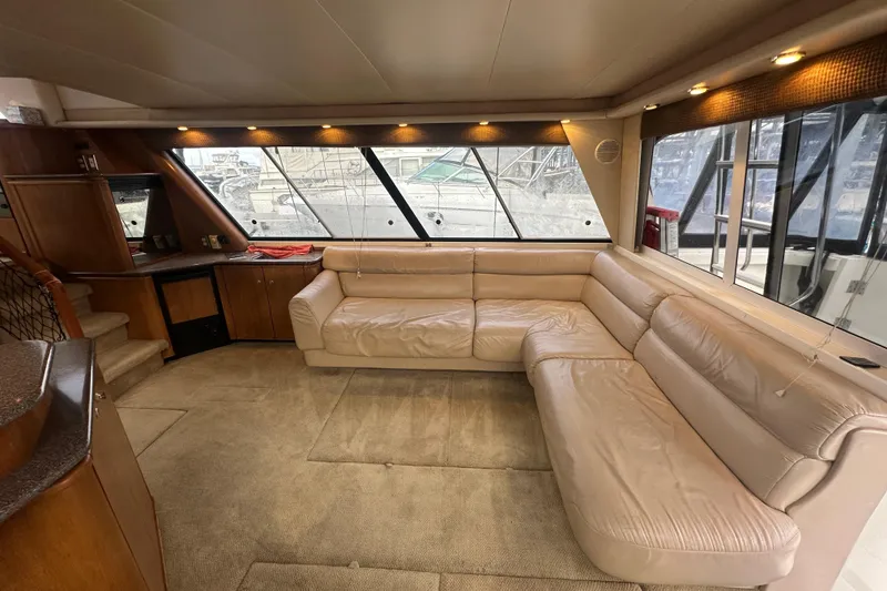 Slide: The Image of Luxurious interior of 1999 Bayliner 4788 Pilot House Motoryacht with beige leather seating. - 11