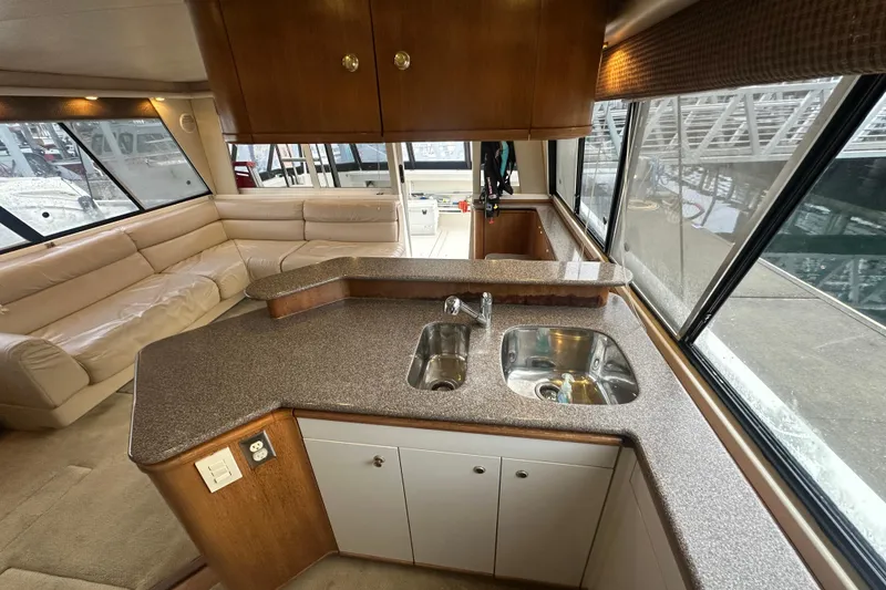Slide: The Image of 1999 Bayliner 4788 Pilot House Motoryacht interior with kitchen and seating area. - 15