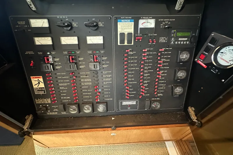Slide: The Image of Control panel of a 1999 Bayliner 4788 Pilot House Motoryacht, featuring various switches and gauges. - 19