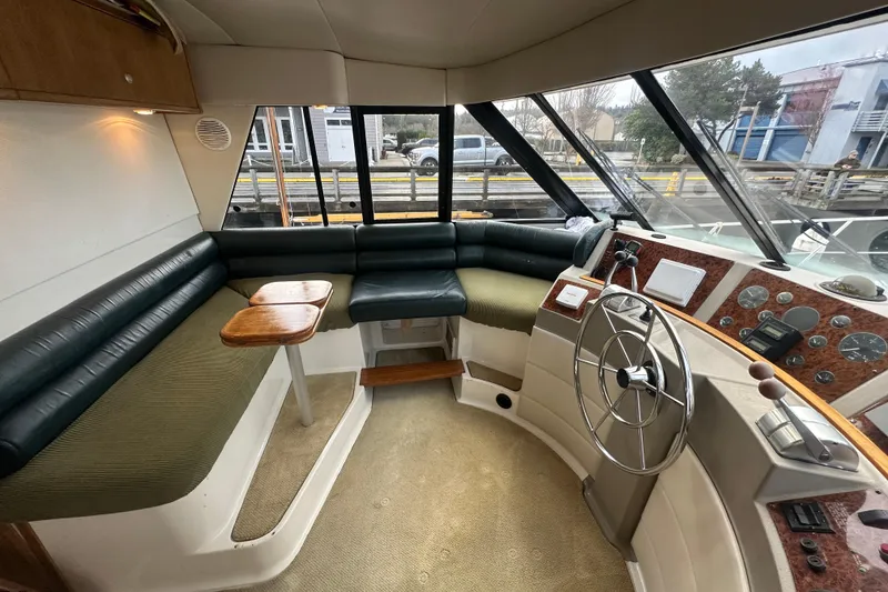 Slide: The Image of Interior of 1999 Bayliner 4788 Pilot House Motoryacht with helm and seating area. - 24
