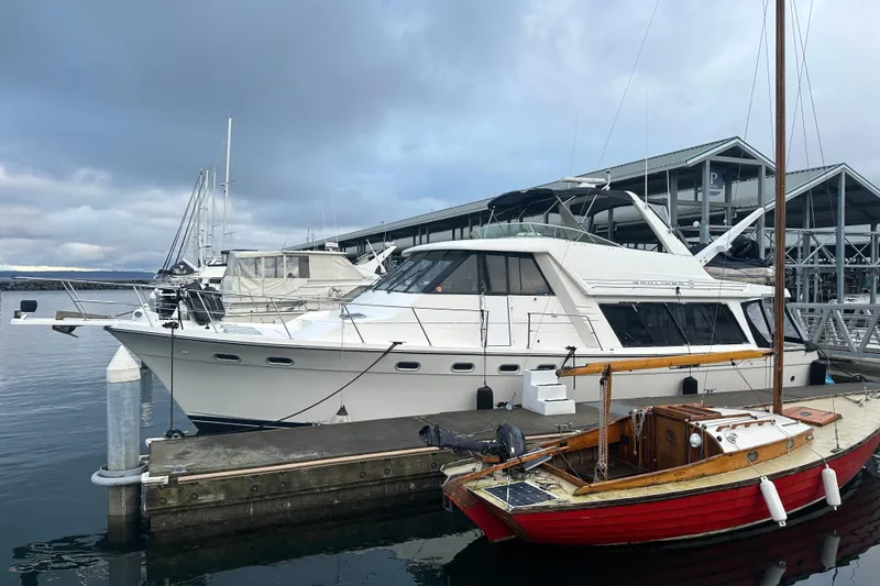 Slide: The Image of 1999 Bayliner 4788 Pilot House Motoryacht docked at marina under cloudy sky. - 3
