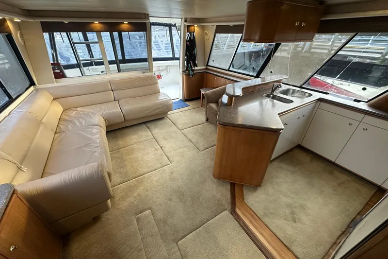 Slide: The Image of Luxurious interior of 1999 Bayliner 4788 Pilot House Motoryacht with spacious seating and kitchen area. - 31