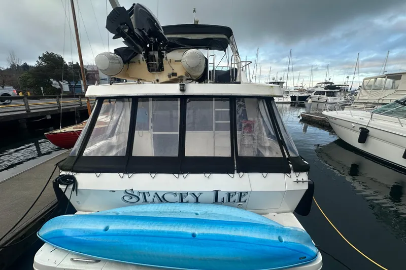 Slide: The Image of 1999 Bayliner 4788 Pilot House Motoryacht docked with blue kayak on stern. - 4