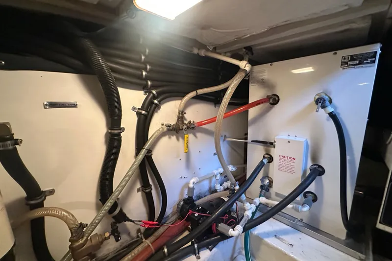 Slide: The Image of Engine room of 1999 Bayliner 4788 Pilot House Motoryacht with fuel and water hoses. - 41
