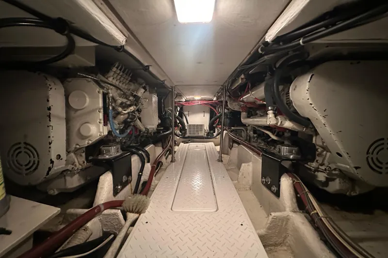 Slide: The Image of Engine room of 1999 Bayliner 4788 Pilot House Motoryacht, showcasing mechanical components. - 42