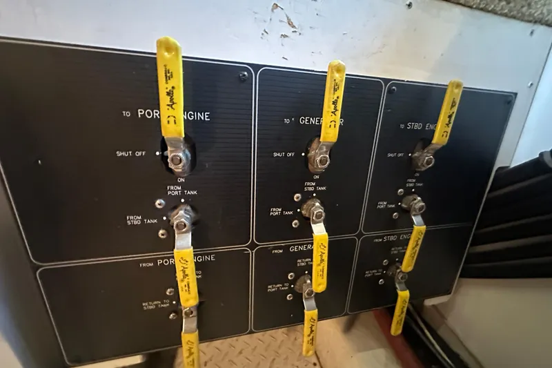 Slide: The Image of Control panel of a 1999 Bayliner 4788 Pilot House Motoryacht with labeled yellow levers. - 43