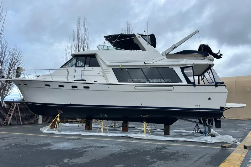 Slide: The Image of 1999 Bayliner 4788 Pilot House Motoryacht on dry dock under cloudy sky. - 44
