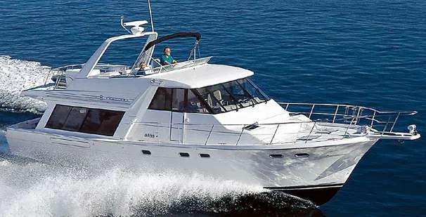 Slide: The Image of 1999 Bayliner 4788 Pilot House Motoryacht cruising on open water. - 48
