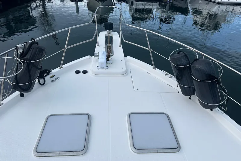 Slide: The Image of 1999 Bayliner 4788 Pilot House Motoryacht bow with fenders and anchor, docked in marina. - 5