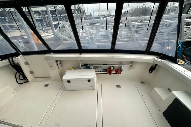 Slide: The Image of 1999 Bayliner 4788 Pilot House Motoryacht cockpit with storage and cooler, docked at marina. - 8