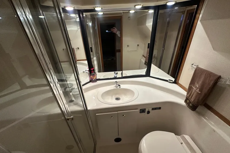 Slide: The Image of Bathroom interior of 1999 Bayliner 4788 Pilot House Motoryacht, featuring sink and mirror. - 9