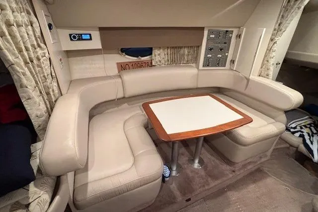 Slide: The Image of 2000 Formula 31 Performance Cruiser interior with beige seating and wooden table. - 14