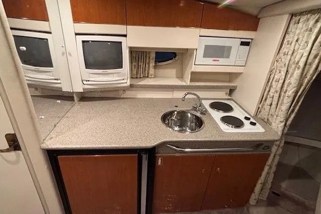 Slide: The Image of 2000 Formula 31 Performance Cruiser kitchen with appliances, sink, and countertop. - 18