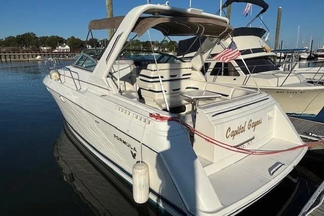 Slide: The Image of 2000 Formula 31 Performance Cruiser docked at marina with American flag. - 2