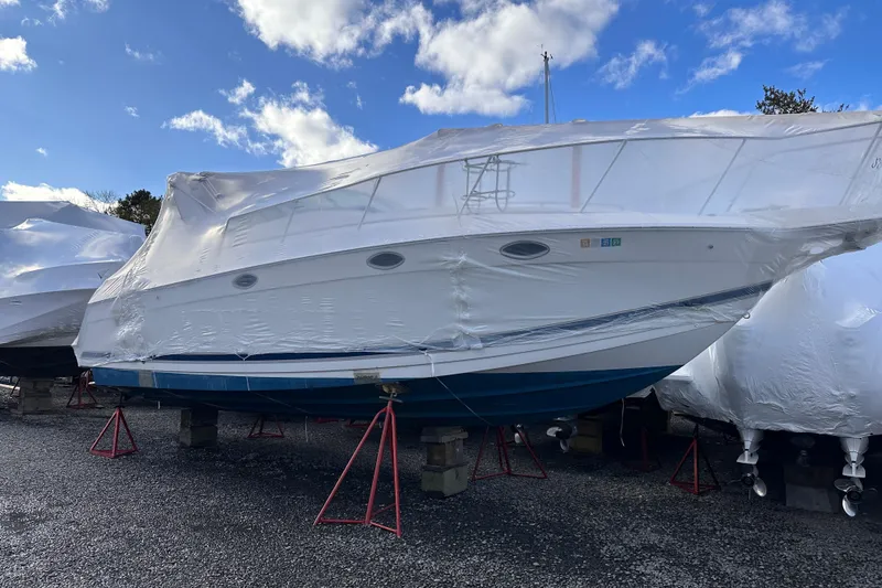 Slide: The Image of 2000 Formula 31 Performance Cruiser wrapped for storage under a clear blue sky. - 26