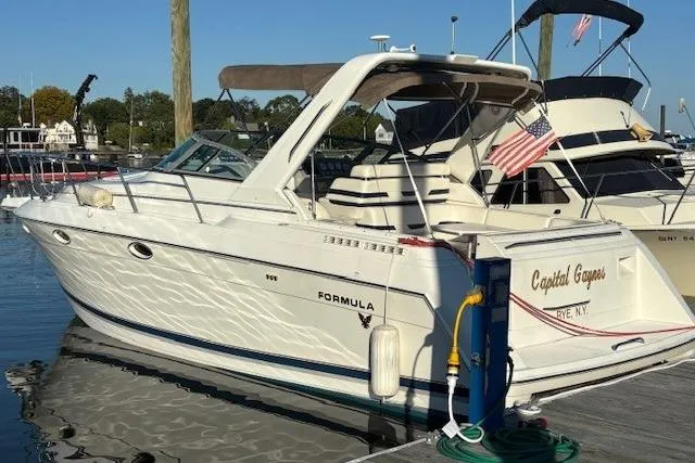 Slide: The Image of 2000 Formula 31 Performance Cruiser docked at marina with American flag. - 4