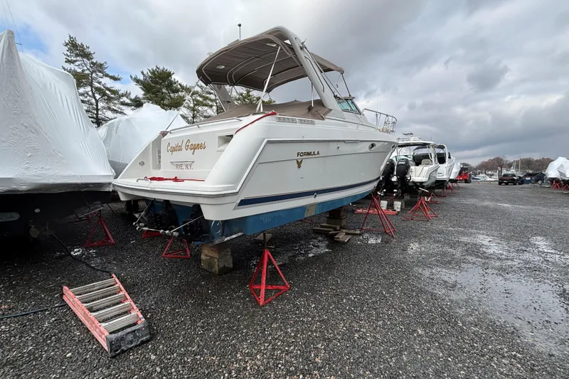 Slide: The Image of 2000 Formula 31 Performance Cruiser on stands in a boatyard, overcast sky. - 5