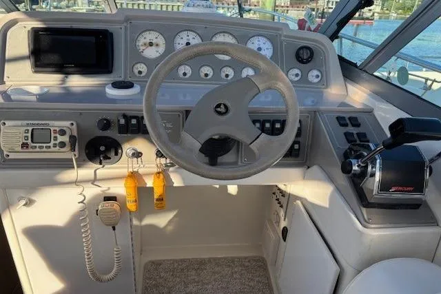 Slide: The Image of Cockpit of 2000 Formula 31 Performance Cruiser with steering wheel and control panel. - 7