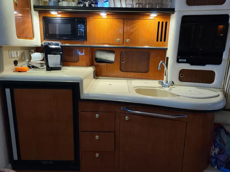 Slide: The Image of Galley kitchen in a 1999 Sea Ray 340 Sundancer yacht. - 13
