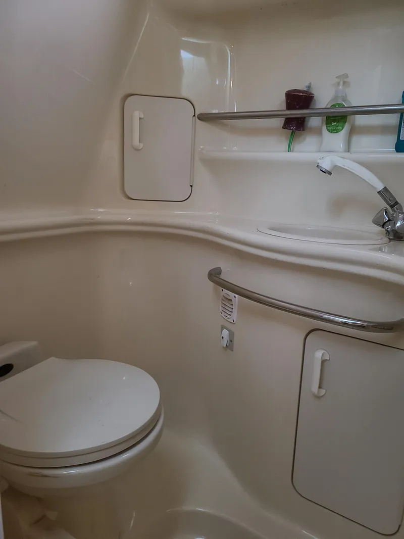 Slide: The Image of 1999 Sea Ray 340 Sundancer bathroom interior with sink and toilet. - 15