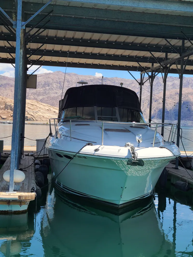 Slide: The Image of 1999 Sea Ray 340 Sundancer docked under covered marina. - 3