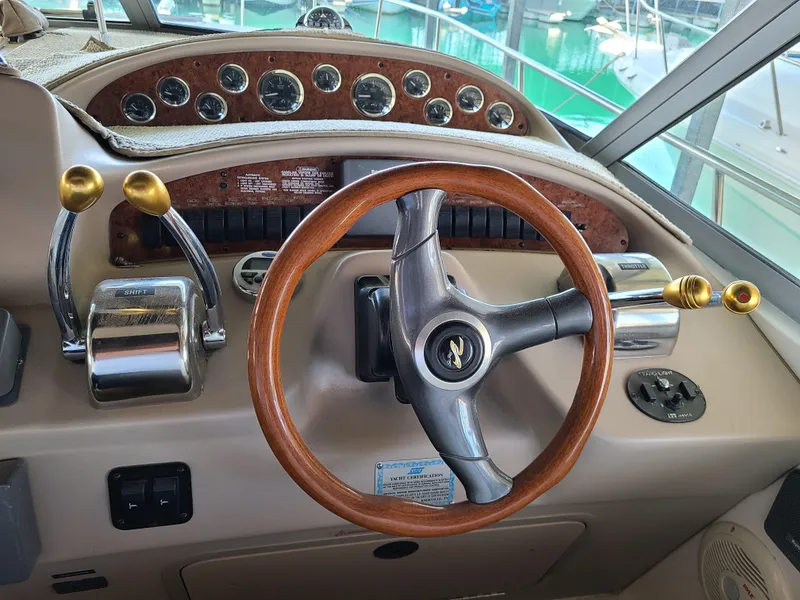 Slide: The Image of 1999 Sea Ray 340 Sundancer helm with wooden steering wheel. - 6