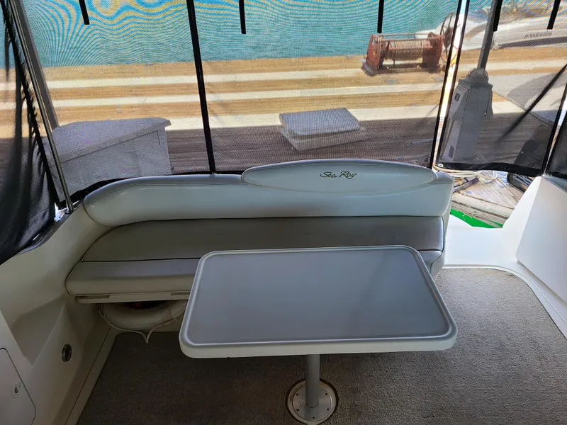 Slide: The Image of 1999 Sea Ray 340 Sundancer interior with seating and table. - 8