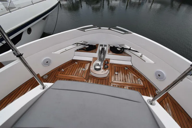 Slide: The Image of 2024 OKEAN 52 yacht bow with teak decking and sleek design. - 18