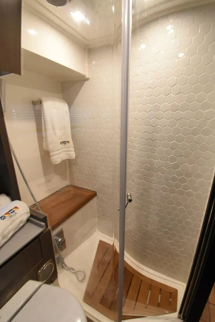 Slide: The Image of Luxurious 2024 OKEAN 52 yacht bathroom with modern shower and wooden accents. - 23