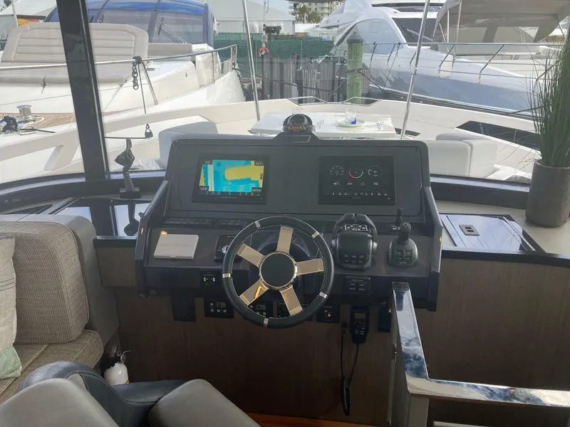 Slide: The Image of 2024 OKEAN 52 yacht helm with modern navigation equipment and steering wheel. - 42