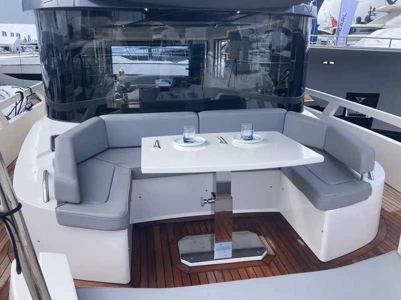 Slide: The Image of 2024 OKEAN 52 yacht with elegant outdoor seating and dining area. - 47