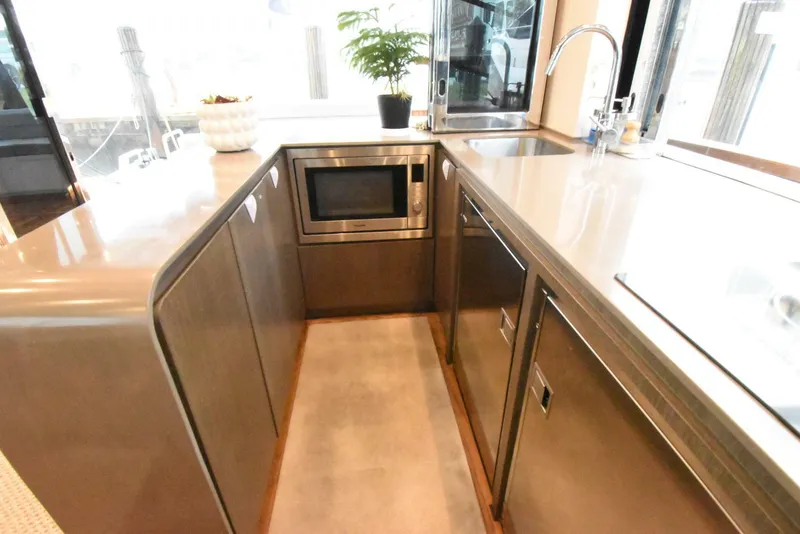Slide: The Image of Modern kitchen area in 2024 OKEAN 52 yacht with sleek cabinetry and appliances. - 7