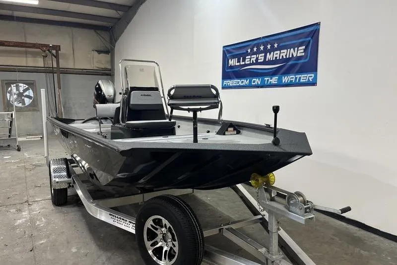 Slide: The Image of 2025 SeaArk Shadow 187T boat on trailer in showroom, Miller's Marine banner visible. - 2