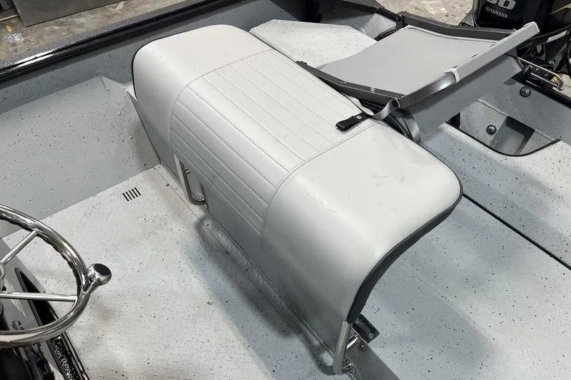 Slide: The Image of 2025 SeaArk Shadow 187T boat interior with white seating and steering wheel. - 8