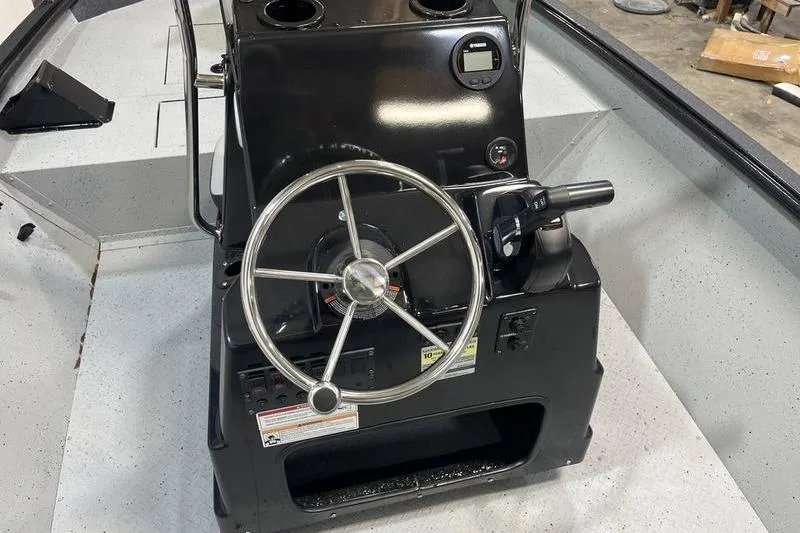 Slide: The Image of 2025 SeaArk Shadow 187T boat console with steering wheel and controls. - 9