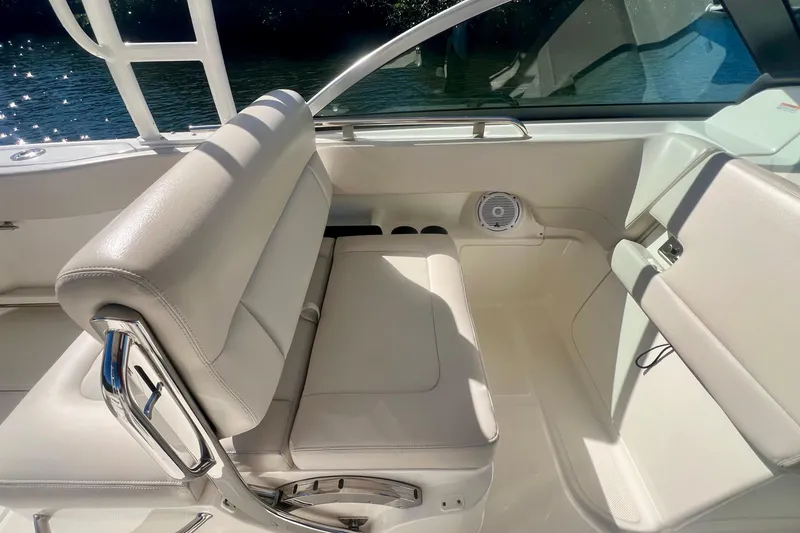 Slide: The Image of 2018 Boston Whaler 230 Vantage interior with white seating and speaker detail. - 10