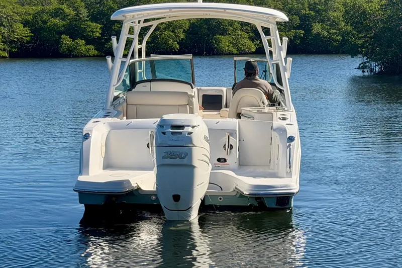 Slide: The Image of 2018 Boston Whaler 230 Vantage boat on calm water, rear view with outboard motor. - 4